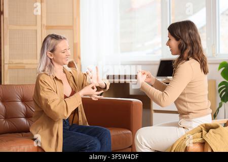 Women using sign language at home Stock Photo