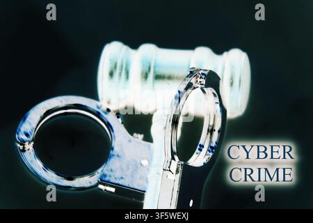 Close-up cinematic image of a judge's gavel and metallic handcuffs with the words "Cyber Crime" displayed as a powerful symbol of digital threats and Stock Photo