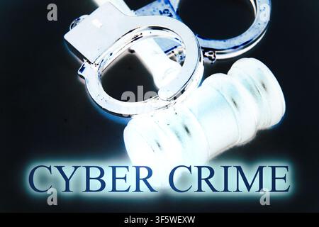 Modern close-up concept featuring a judge's hammer and steel handcuffs with the inscription "Cyber Crime" against a pure black background. The image s Stock Photo