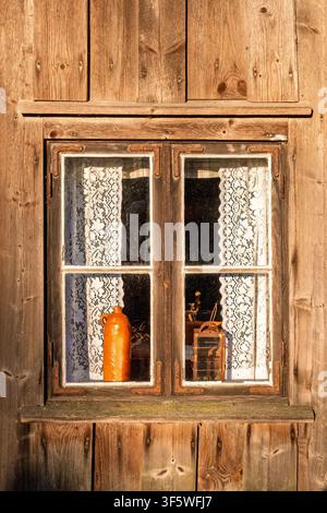 Rustic wooden croft window with lace curtains Stock Photo