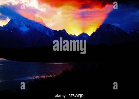 Awesome sunset with sunbeams over the mountain range in the Rocky mountains Stock Photo