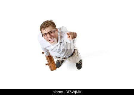 Smiling young businessman pointing toward camera in dramatic overhead view Stock Photo