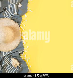 Beach straw sun hat, seashells on yellow background. Square Summer holiday background. Top view. Stock Photo