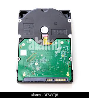 A close up top view of a computer hard disk drive showing its green circuit board against a white background Stock Photo
