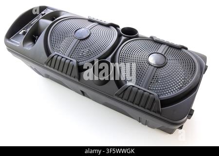 A modern black portable stereo speaker is angled on a clean white background Stock Photo