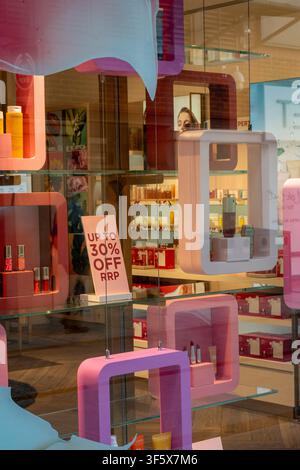 Colourful selection of cosmetics and beauty products on display in the window of a designer shop in Gunwharf Quays shopping centre, Portsmouth, UK Stock Photo