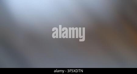 An abstract background featuring a smooth, metallic grey gradient with a subtle, structured block or grid pattern overlay. Stock Photo