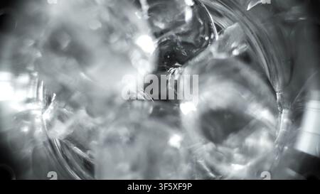 Ice cubes swirling in a glass of water, capturing cold refreshment and abstract liquid reflections Stock Photo