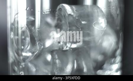 Ice cubes and water filling a glass creating a refreshing, cool beverage with condensation on the clear surface Stock Photo