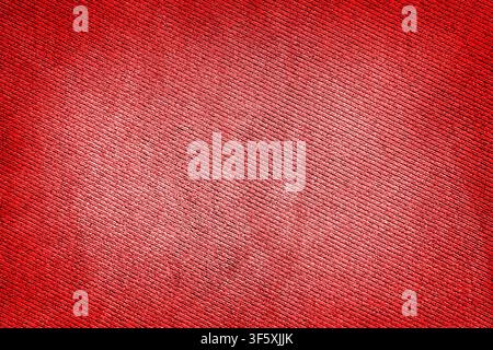 Red fabric woven texture macro background high contrasted with vignetting effect Stock Photo