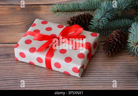 a christmas gift with pine branches and cones close up Stock Photo