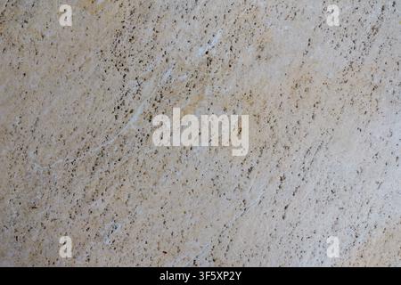 Beige decorative tile with dark speckles, diagonal lines and uneven finishing surface texture shown close up Stock Photo