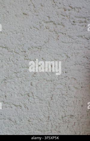 Close up of rough white plaster with pronounced irregularities, porous structure and natural surface relief Stock Photo