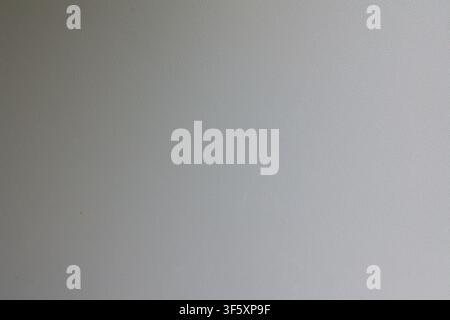 Light gray surface with uniform fine grained texture and subtle monochrome pattern covering the entire frame Stock Photo