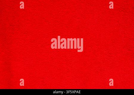 Bright red terry fabric close up with dense soft pile and pronounced textile surface structure Stock Photo