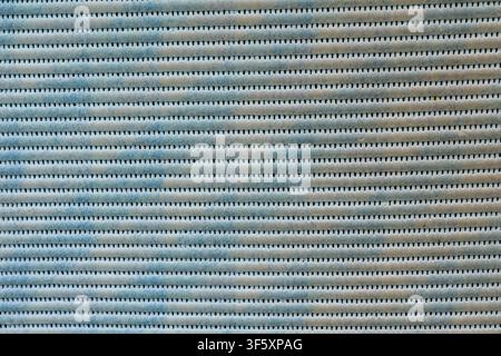 Abstract texture of light material with horizontal lines, small gaps and a pronounced repeating surface relief Stock Photo