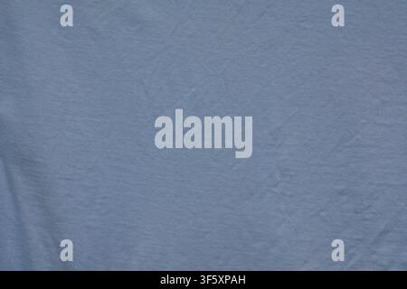 Solid blue fabric close up with fine textile texture, soft folds and small natural surface irregularities Stock Photo