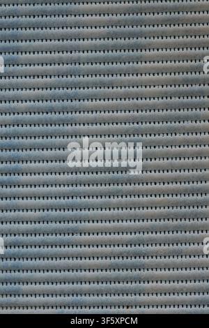 Gray blue textured surface with horizontal stripes and repeating structure. Stock Photo