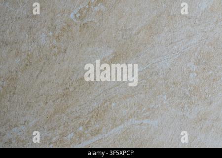Close up of light beige tile with uneven shades, natural marks and an expressive stone surface texture Stock Photo