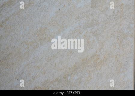 Close up of light beige tile with soft natural shades and an uneven fine grained surface texture Stock Photo