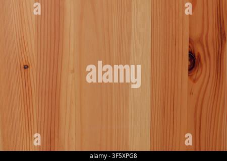 Light natural pine wood surface with even vertical grain, warm tones and several contrasting dark knots Stock Photo