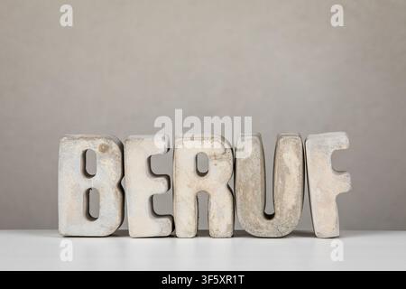 Career Meaning From German Word BERUF Shown With Minimal Concrete Typography On Background Stock Photo