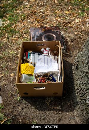 A 'Free to Give Away' box in a meadow full of costume jewelry and stuff, taken in Berlin, August 3, 2026. Stock Photo