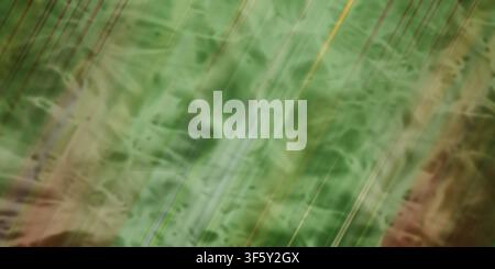 An abstract background with a textured green surface, overlaid with diagonal light streaks and subtle striped patterns. Stock Photo