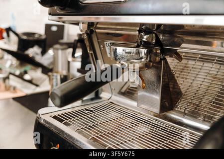 Professional espresso machine with portafilter ready for brewing in a specialty coffee shop. Stainless steel coffee equipment for barista workflow. Stock Photo