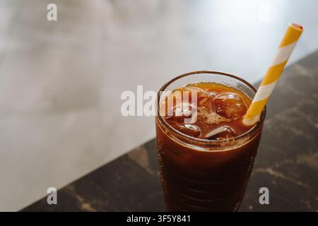 Close up of refreshing iced coffee with ice cubes in a textured glass. Minimal composition with soft background and copy space. Stock Photo