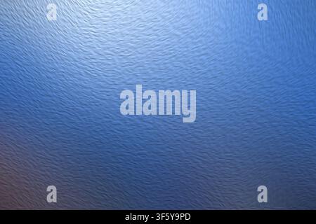 A sophisticated abstract background showcasing a detailed rippled surface texture with a rich blue gradient and bright light reflections. Stock Photo