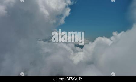 Flying through white fluffy clouds Stock Photo