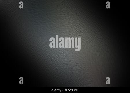 A dark, moody abstract background featuring a swirling, circular pattern with a textured, painterly effect, creating a sense of depth and movement. Stock Photo