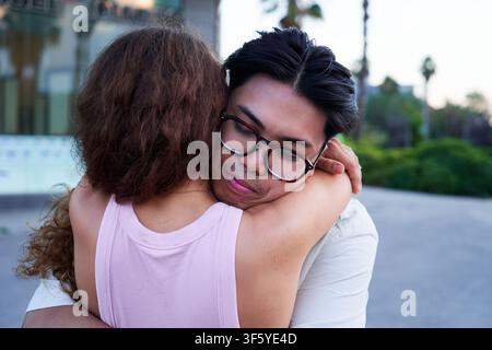 Happy couple embracing in the city: expressing love and affection Stock Photo