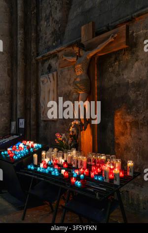 Votive candles in colourful red and blue glass cups at Chartres Cathedral - Cathedral of Our Lady of Chartres (Cathédrale Notre-Dame de Chartres). Stock Photo