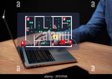 Creating an emergency evacuation plan on a laptop Stock Photo