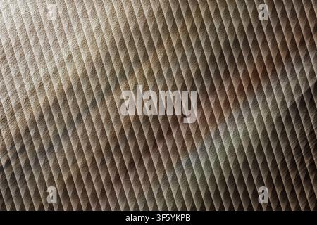 An abstract background image showing a diagonal ribbed texture, characterized by a blend of earthy brown and metallic grey tones. Stock Photo