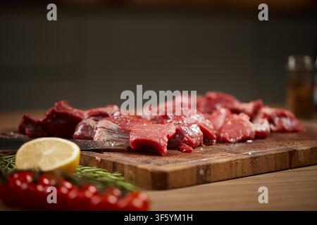 Diced raw beef pieces on cutting board Stock Photo