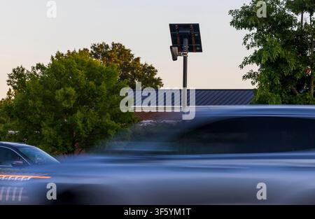 A Flock Camera, an automated license plate reader mounted on a solar-powered pole, stands along East Little Creek Road in Norfolk, Virginia, on May 21, 2024. The device is part of a growing network of automated license plate reader technology deployed by law enforcement agencies across the United States to monitor vehicle traffic and assist in criminal investigations. (Photo by Kendall Warner/The Virginian-Pilot/TNS/Sipa USA) Stock Photo