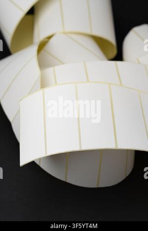 Rolls of blank white adhesive labels isolated on white for direct thermal and thermal transfer printing, packaging, pricing and retail use. Stock Photo