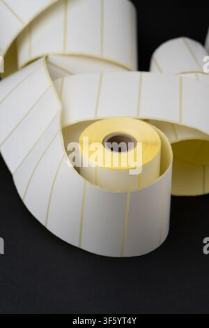 Rolls of blank white adhesive labels isolated on white for direct thermal and thermal transfer printing, packaging, pricing and retail use. Stock Photo