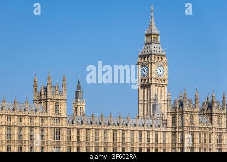 Elizabeth Tower, home to Big Ben, rises above the Palace of Westminster on a clear blue-sky day in London, England, United Kingdom Stock Photo