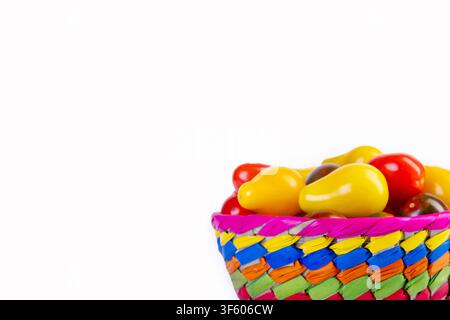 Bright and colorful assorted cherry tomatoes (yellow pear-shaped, red and black striped) in a vivid basket on the white background. Fresh organic gard Stock Photo
