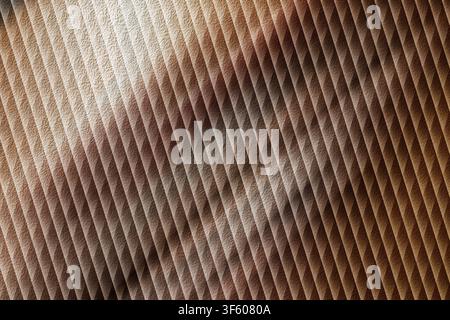 A textured background with repeating diagonal lines, featuring warm brown and golden tones with soft light and shadow effects. Stock Photo