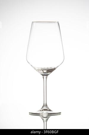 Empty crystal stemware glass reflecting on a clean white background Stock Photo