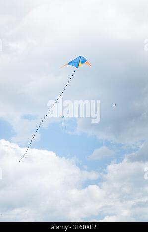 Kites flying in the sky on a cloudy day Stock Photo
