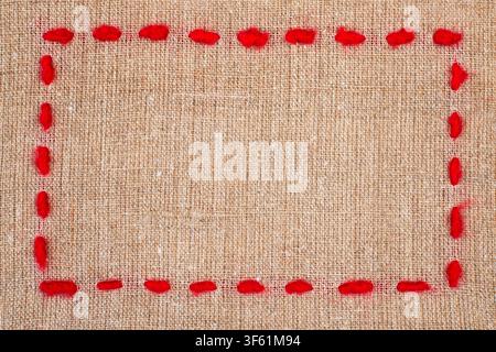 Red Yarn Frame on Burlap Texture Background Stock Photo
