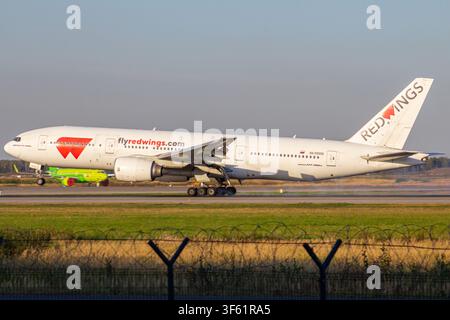 Commercial passenger jet of Red Wings Airlines taxiing on the airport tarmac during daytime Stock Photo