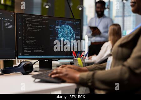Close up of programmer in office typing on keyboard, using AI to streamline app development. IT specialist writing code at desk using PC to run debugging programs with machine learning technology Stock Photo