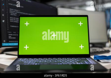 Close up of green screen laptop on startup office desk showing deep learning programming languages written by programmers. Mockup notebook in AI company used for code testing and quality assurance Stock Photo